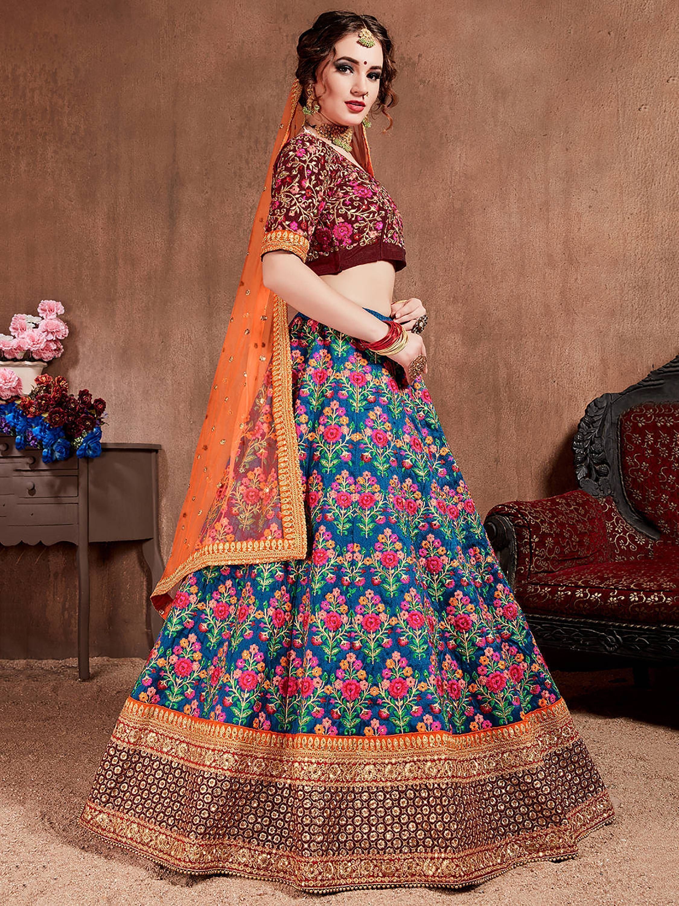 Designer lehenga choli with floral embroidery, vibrant colors, and orange dupatta for Indian ethnic wear