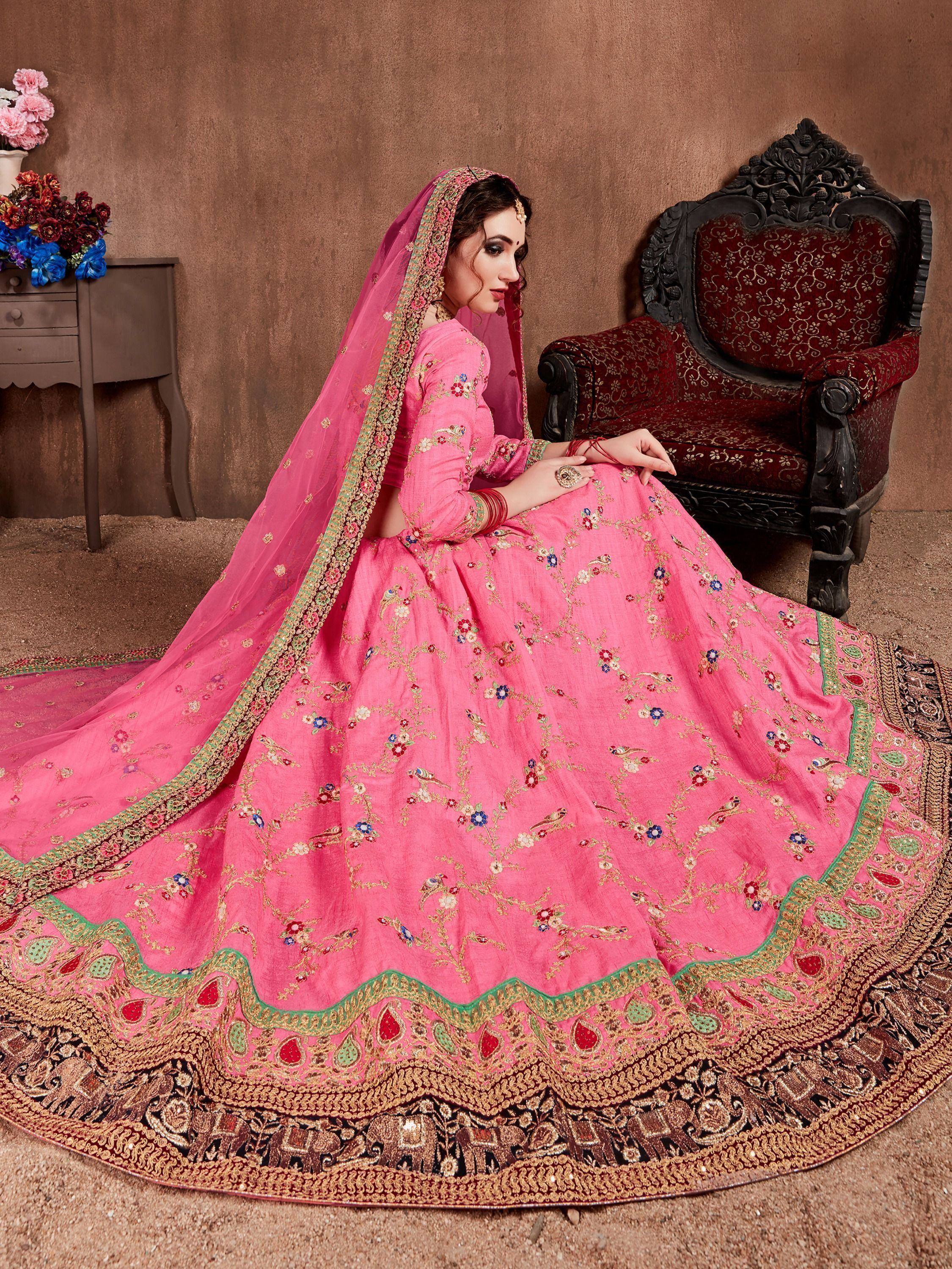 Pink embroidered lehenga choli with floral motifs and heavy border, perfect for Indian weddings and festive occasions.